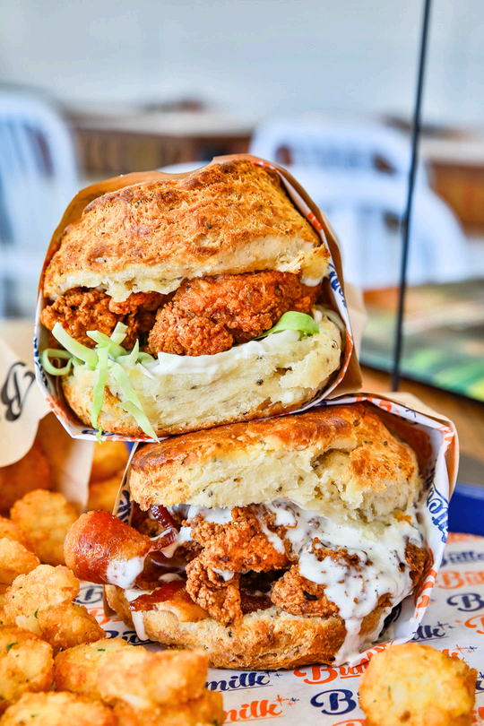 Fried chicken biscuit sandwich with tater tots